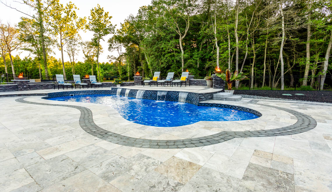 Leisure Pools Eclipse freeform fiberglass swimming pool with built-in splash deck
