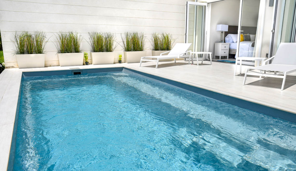 Leisure Pools Harmony fiberglass inground swimming pool with built-in bench seat