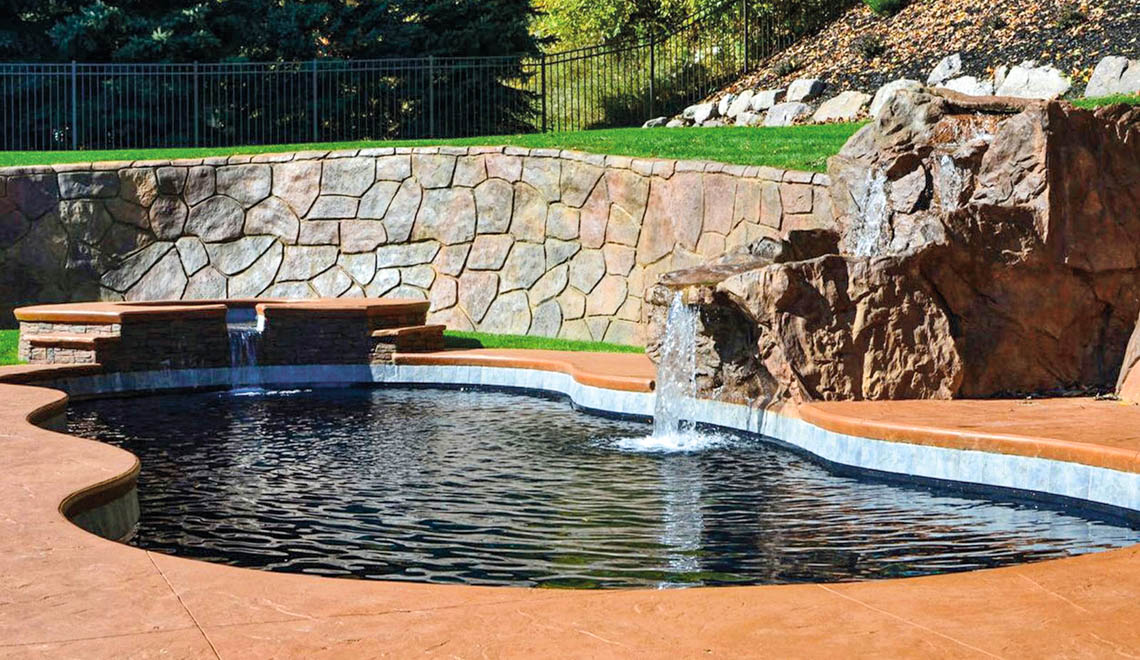 Leisure Pools Mediterranean fiberglass freeform swimming pool with wrap-around bench