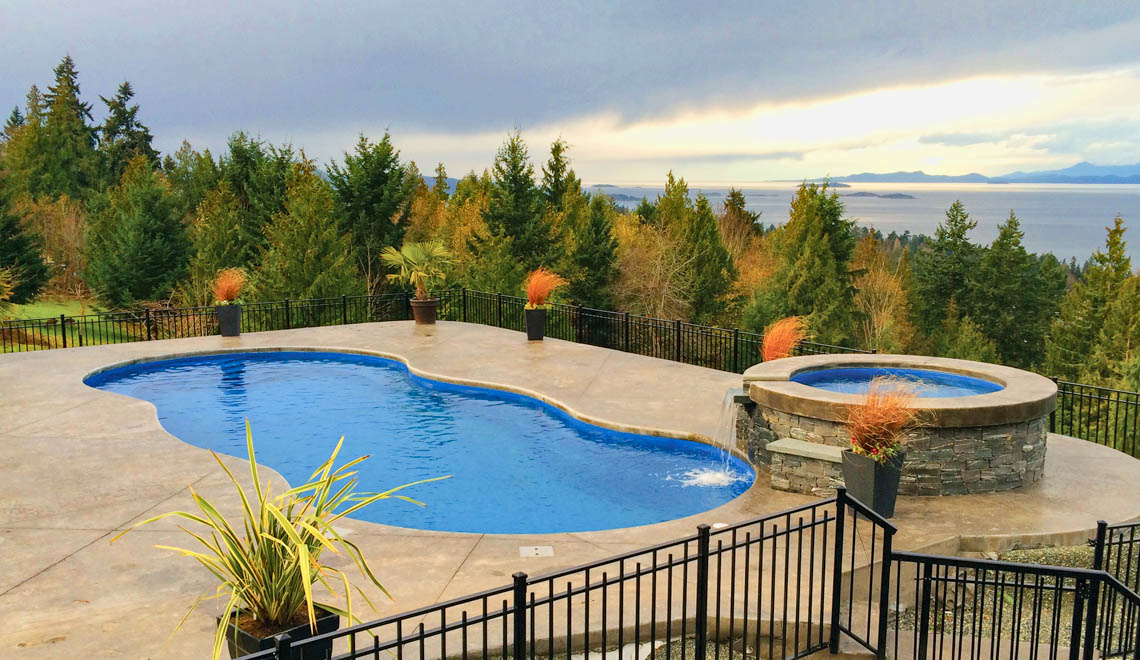 Leisure Pools Mediterranean fiberglass freeform swimming pool with wrap-around bench