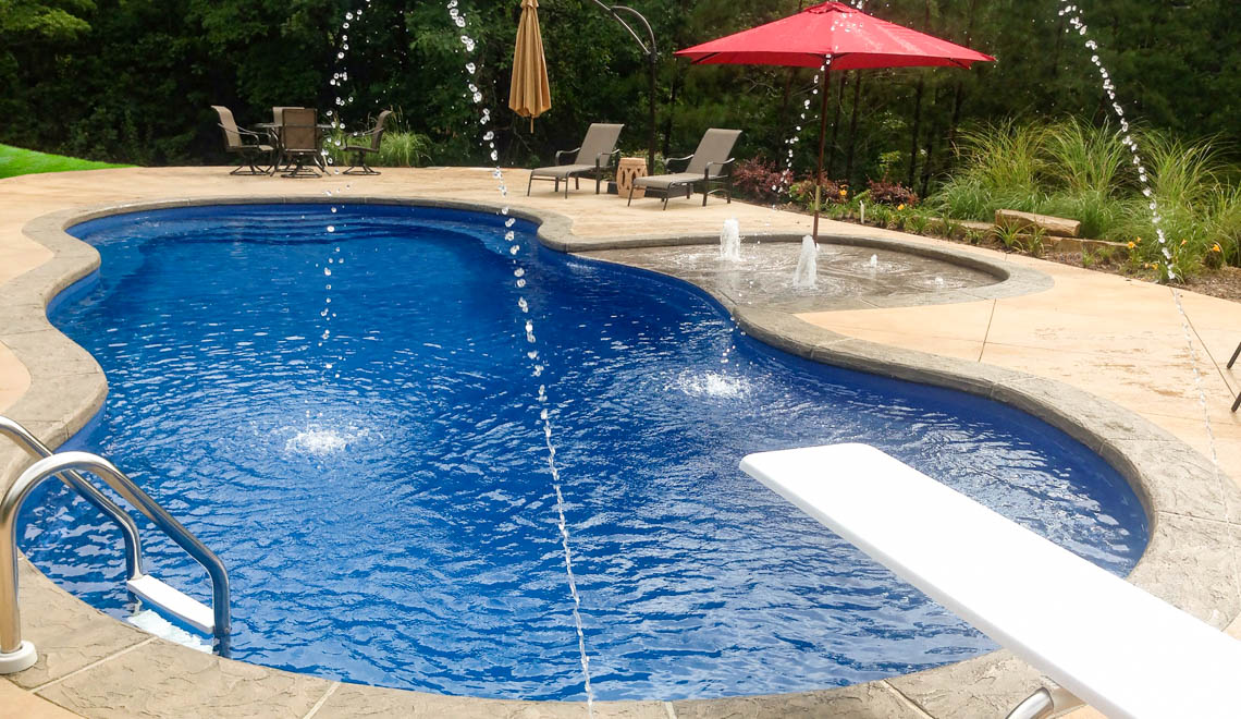 Leisure Pools Mediterranean fiberglass freeform swimming pool with an 8-foot depth