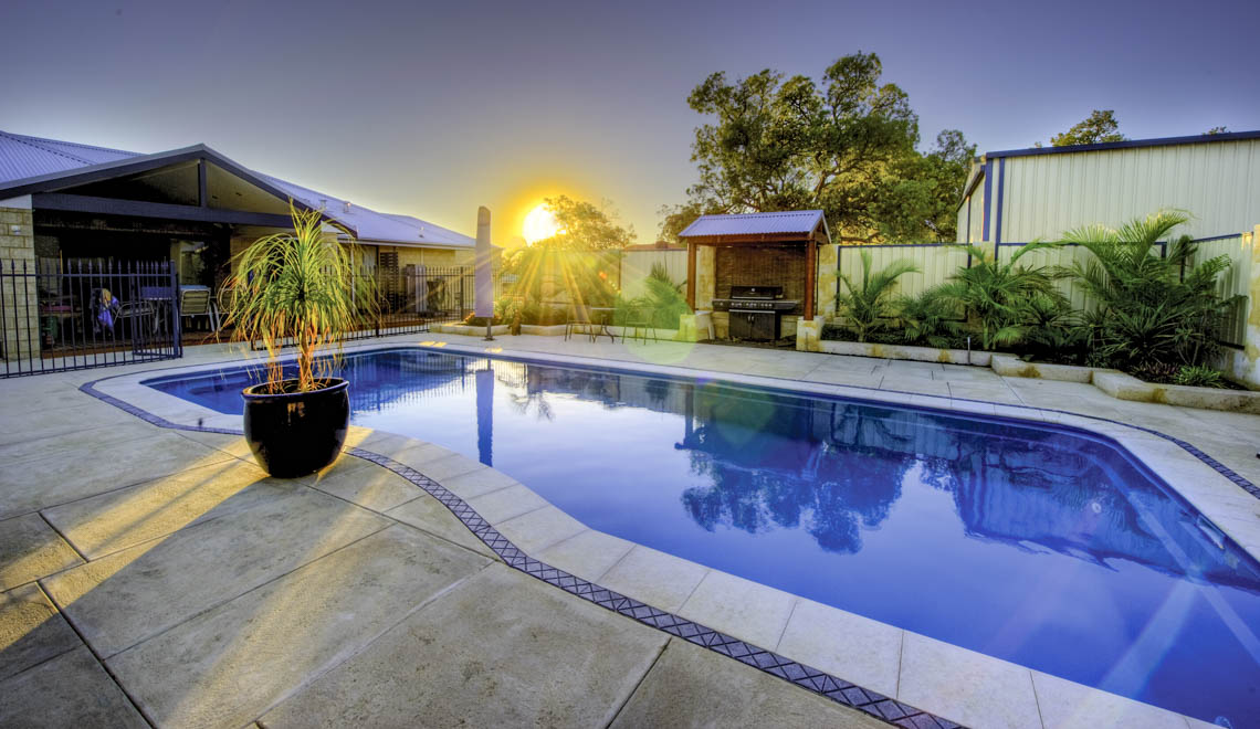Leisure Pools Moroccan large fiberglass swimming pool with wrap-around perimeter swimout