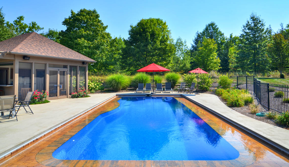 Leisure Pools Moroccan fiberglass swimming pool with built-in steps and swim-out bench