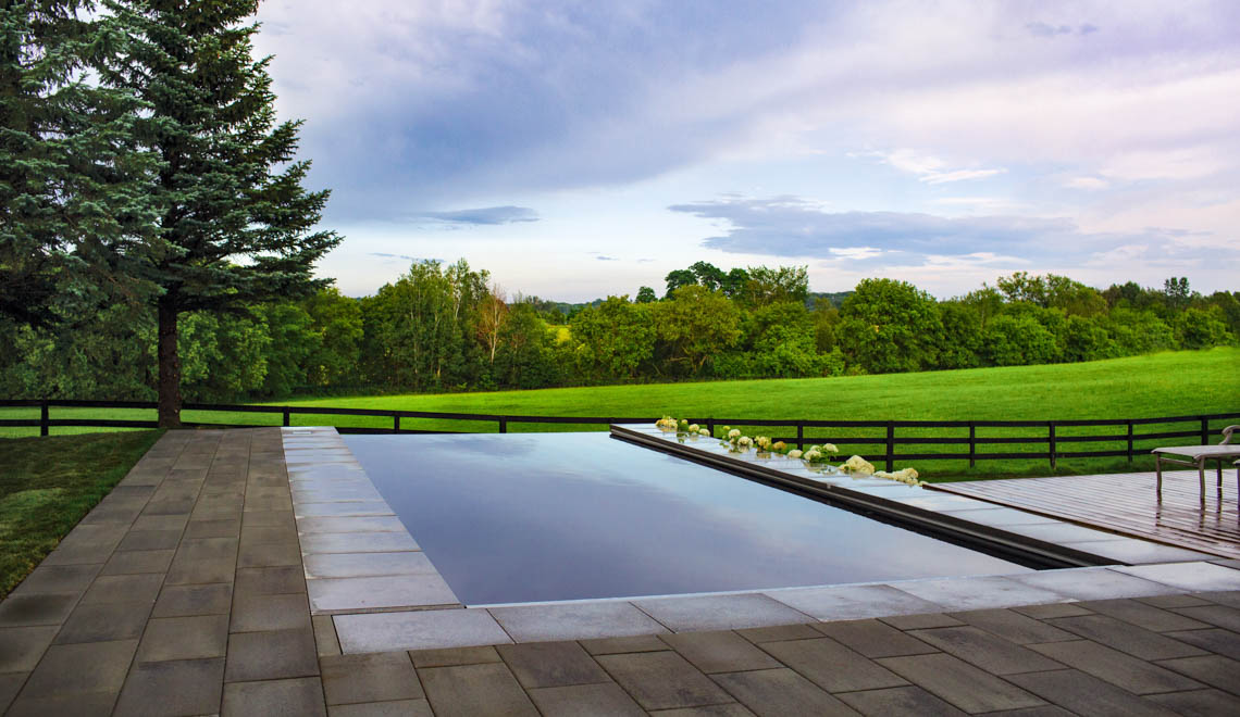 Leisure Pools Pinnacle large fiberglass swimming pool with built-in splash deck