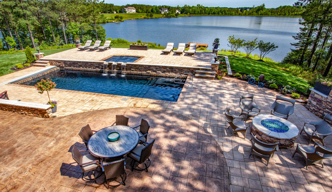 Leisure Pools Pinnacle large fiberglass swimming pool with built-in splash deck