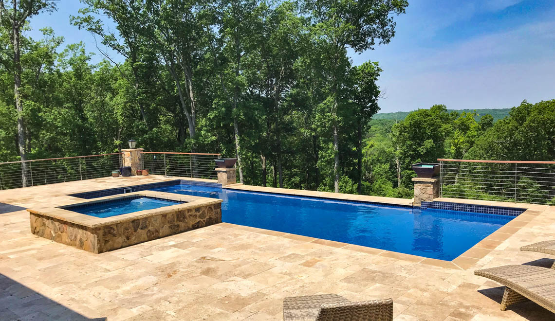 Leisure Pools Pinnacle large fiberglass swimming pool with built-in splash deck