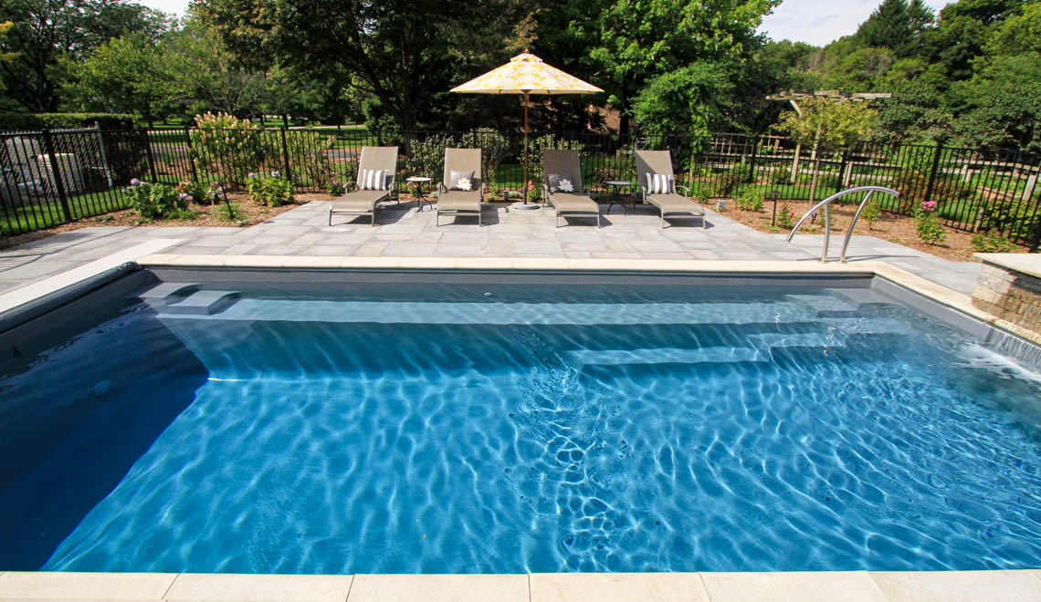Leisure Pools Reflection composite fiberglass swimming pool with full-length bench seat