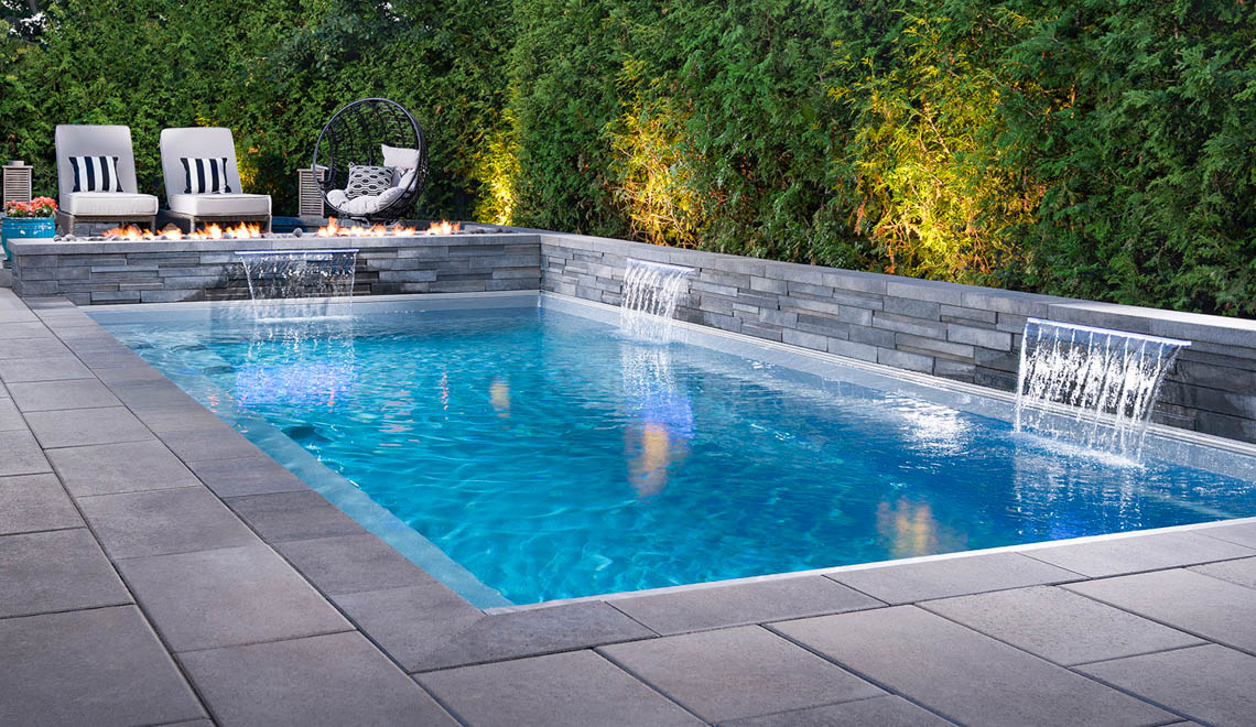 Leisure Pools Reflection fiberglass swimming pool with full-length bench seat