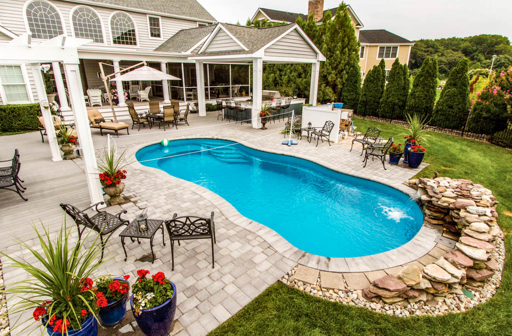Leisure Pools Riviera composite fiberglass freeform swimming pool with generous entry and exit steps