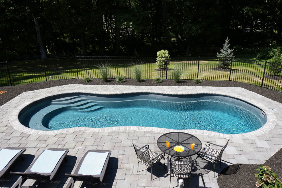 Leisure Pools Riviera large composite fiberglass swimming pool with wrapped bench seat