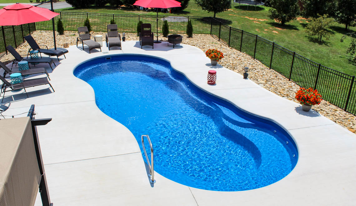 Leisure Pools Riviera composite fiberglass freeform swimming pool with perimeter swimout