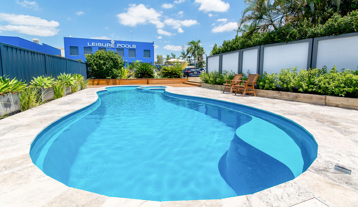 Leisure Pools Allure freeform inground swimming pool with built-in spa and splash deck