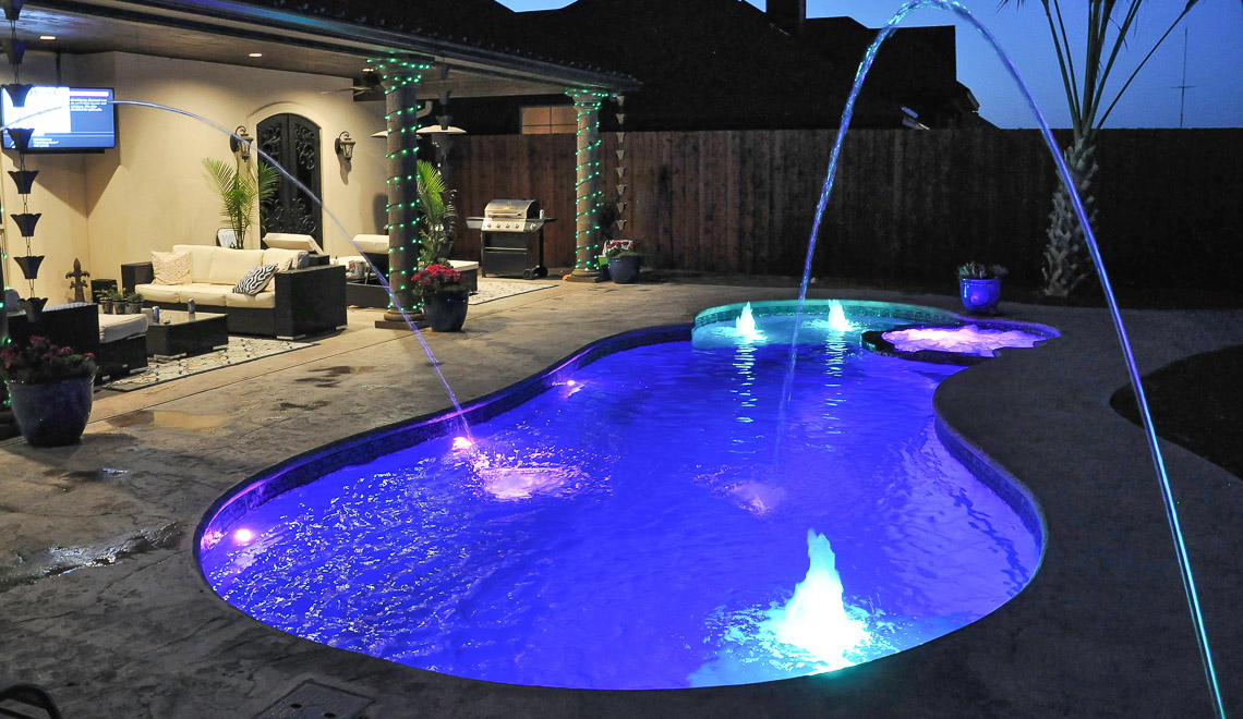 Leisure Pools Allure large freeform swimming pool with built-in spa and splash deck
