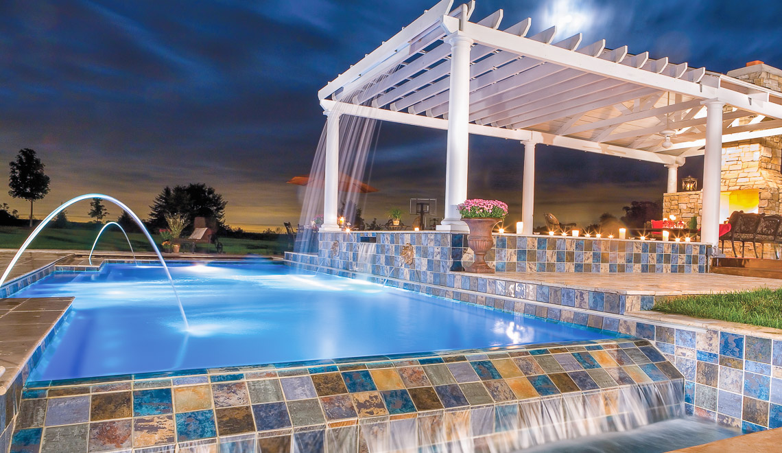 Leisure Pools Elegance fiberglass swimming pool with spill-over edge