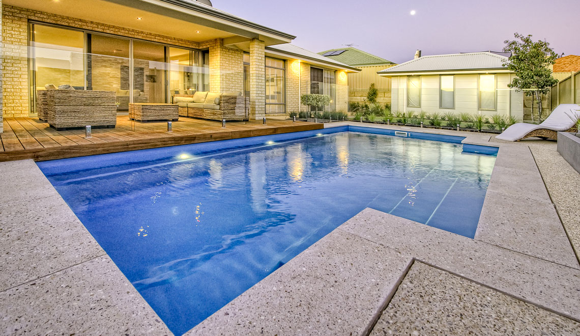 Leisure Pools Elegance fiberglass swimming pool with built-in bench seat