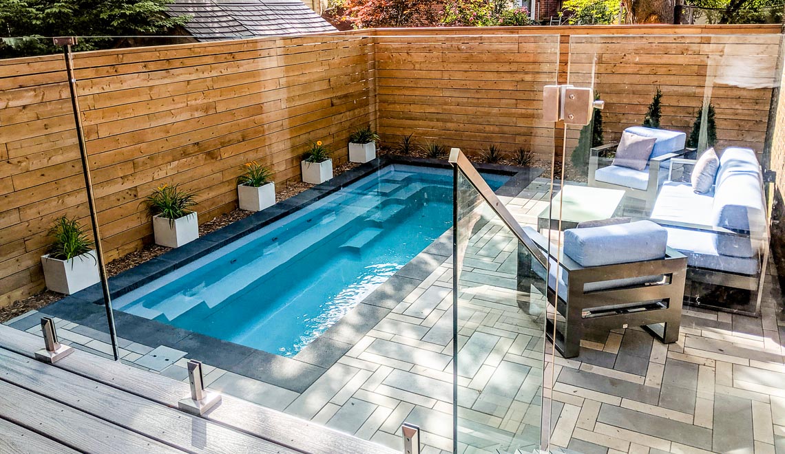 Leisure Pools Esprit compact fiberglass swimming pool with built-in bench