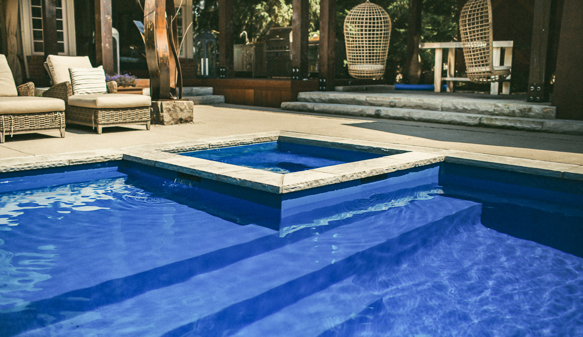 Leisure Pools Icon composite swimming pool with built-in spa and splash deck