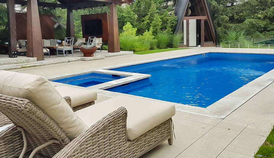 Leisure Pools Icon large fiberglass swimming pool with built-in spa and splash deck