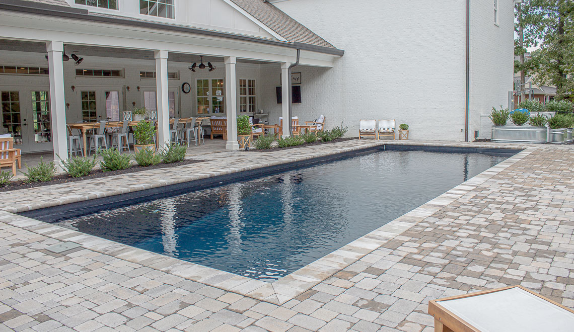 Leisure Pools Infinity large precast composite swimming pool with built-in steps and bench