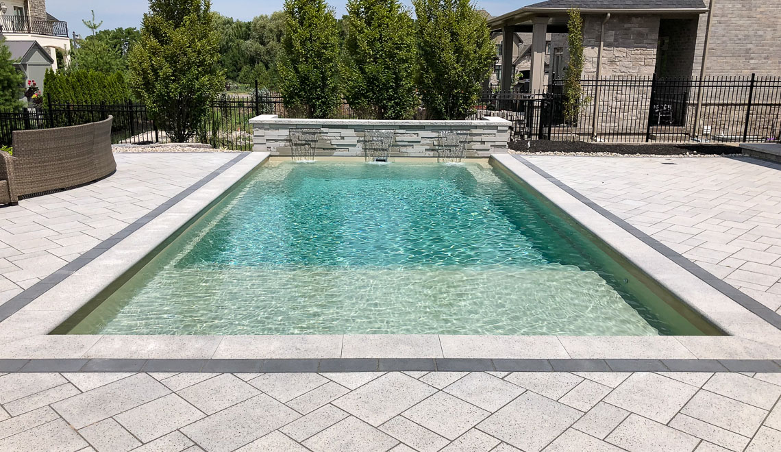 Leisure Pools Summit large composite fiberglass swimming pool with integrated splash deck