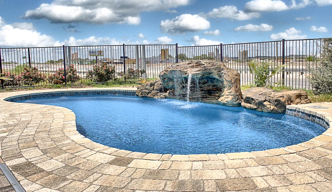 Leisure Pools Tuscany freeform fiberglass swimming pool with perimeter swimout