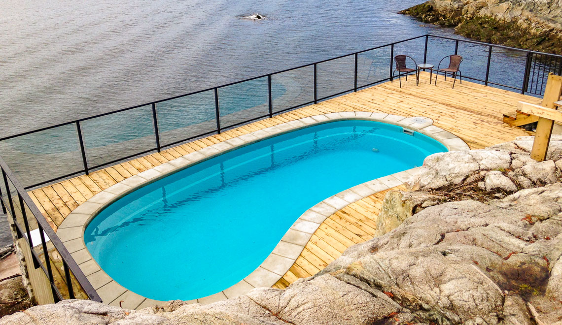 Leisure Pools Tuscany freeform composite swimming pool with deep end seat and swimout