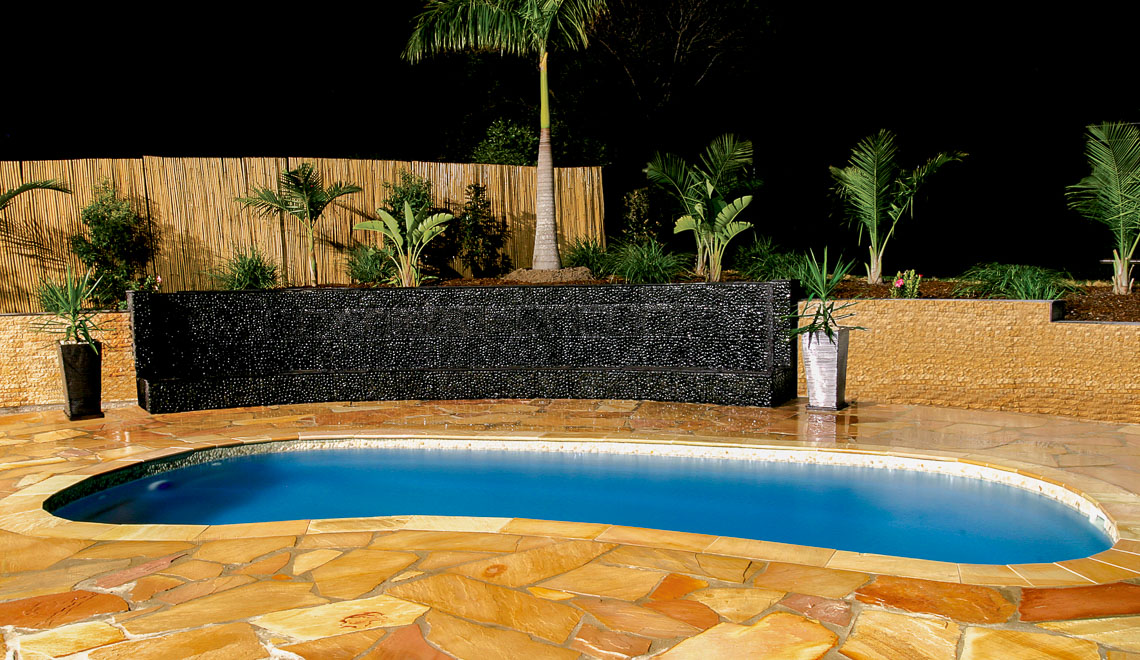 Leisure Pools Tuscany freeform fiberglass swimming pool with perimeter swimout