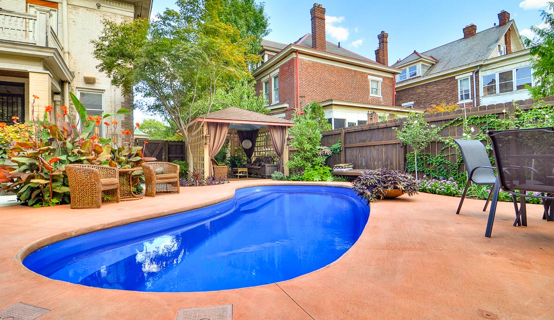 Leisure Pools Tuscany composite fiberglass swimming pool with deep end seat and swimout