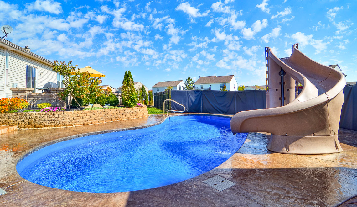 Leisure Pools Tuscany freeform composite fiberglass swimming pool with perimeter swimout