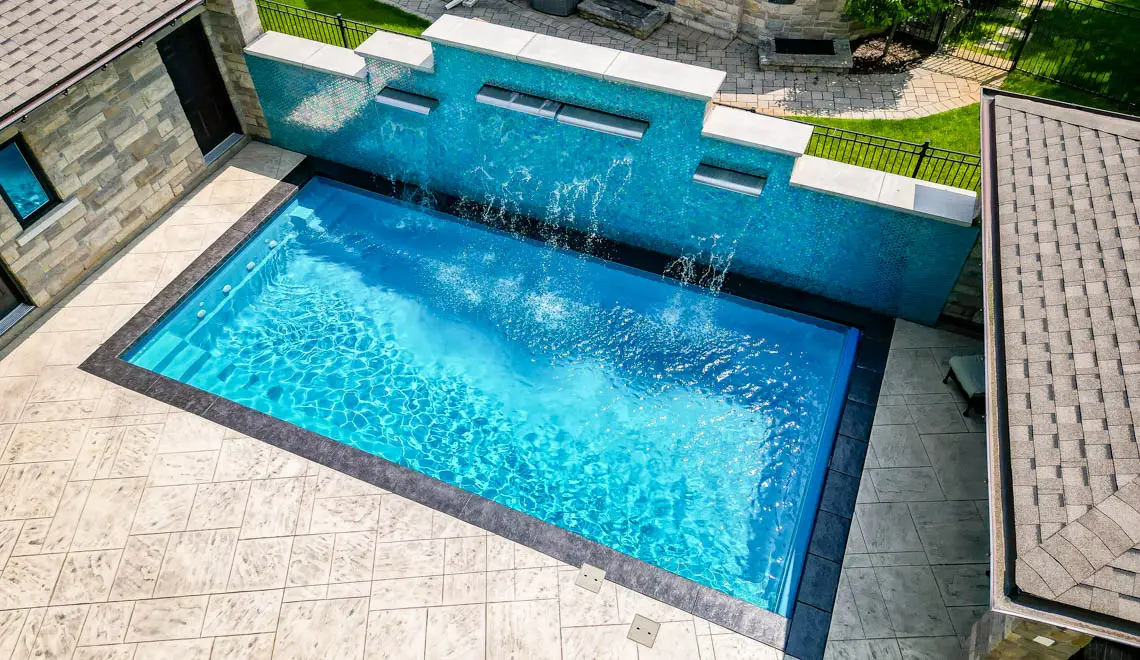 Leisure Pools Supreme composite in-ground swimming pool with bench seats in Crystal Blue
