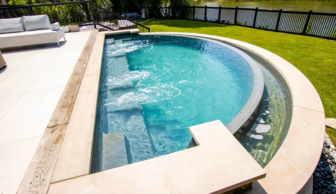 Leisure Pools Horizon composite fiberglass swimming pool with an infinity edge
