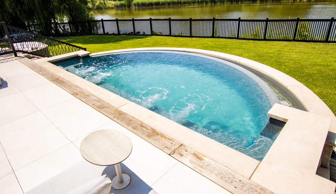Leisure Pools Horizon composite fiberglass swimming pool with an infinity edge