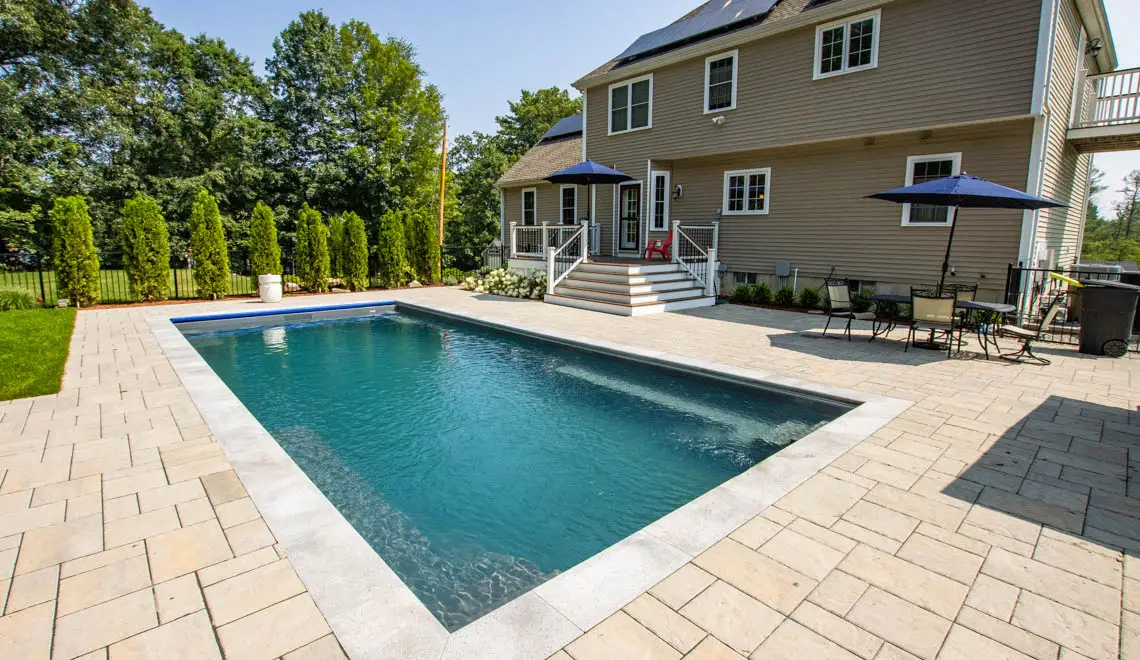 Leisure Pools Supreme inground fiberglass swimming pool with swim out ledges in Graphite Grey