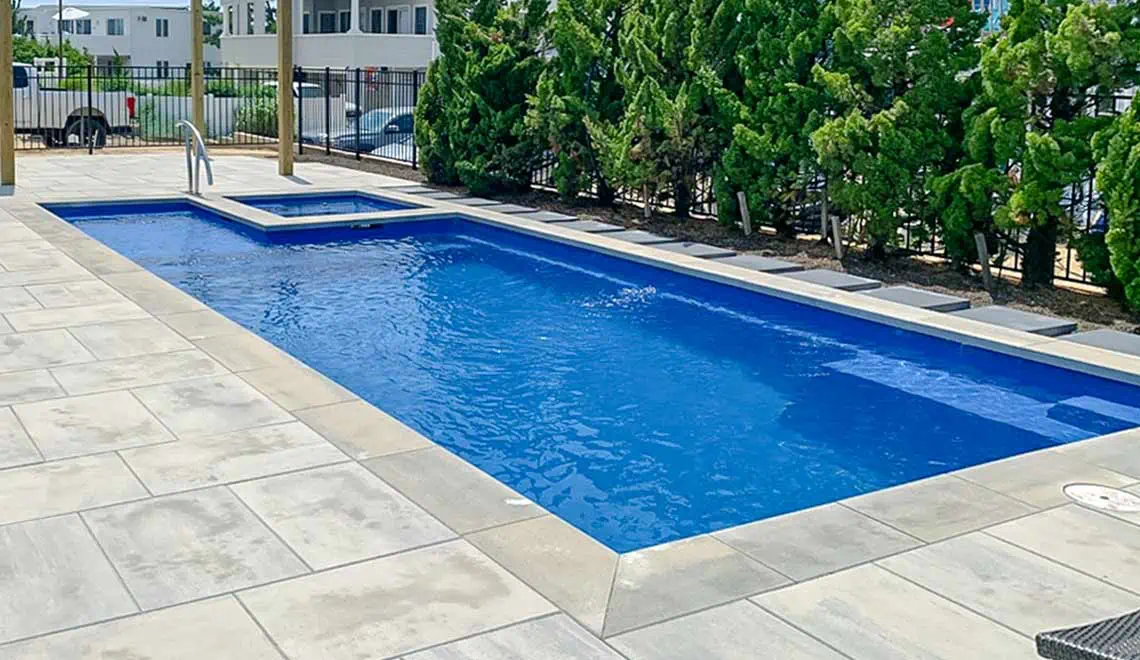 Leisure Pools Limitless composite fiberglass swimming pool with built-in spa