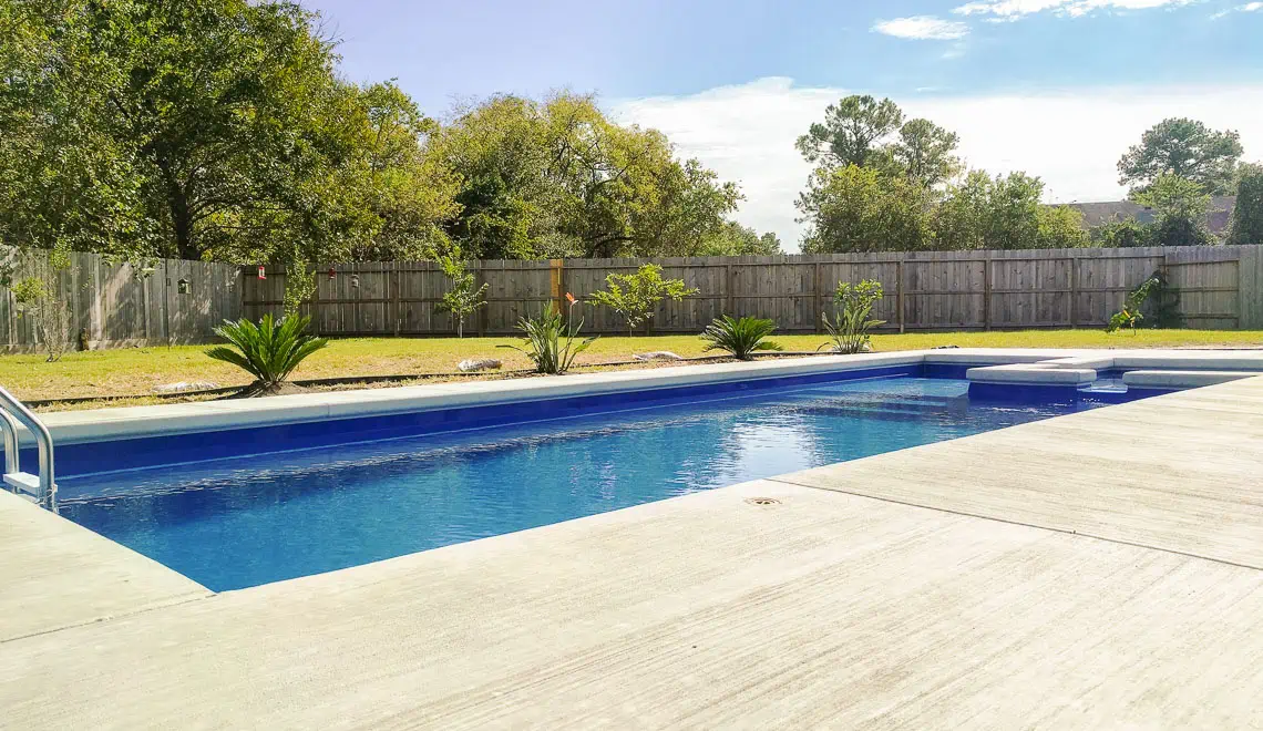 Leisure Pools Limitless composite swimming pool with built-in spa and tanning ledge